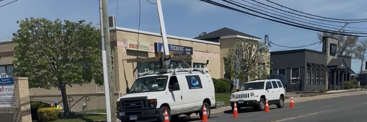 TTG crew managing active work zone with cones and utility trucks