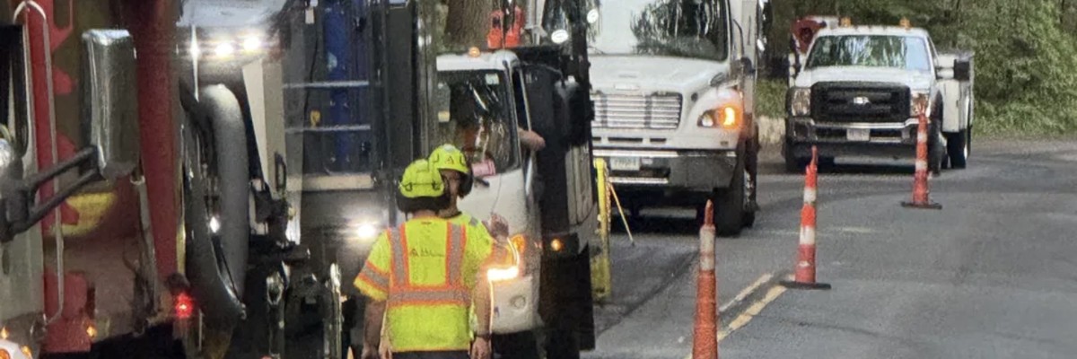 Active road work zone Connecticut with utility trucks and crew